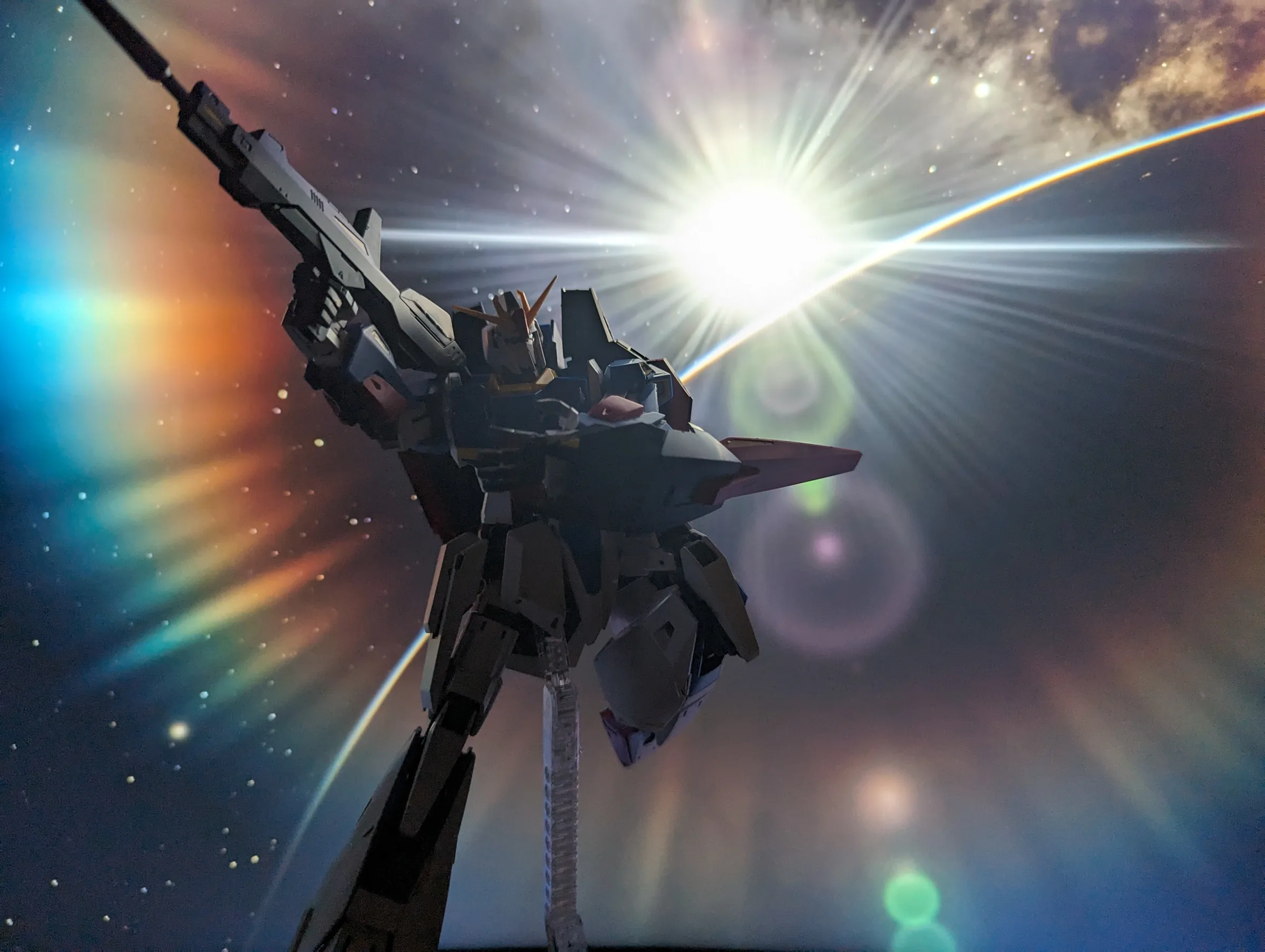 MSZ-006 Zeta Gundam aiming a rifle against a bright starburst over a planet's horizon